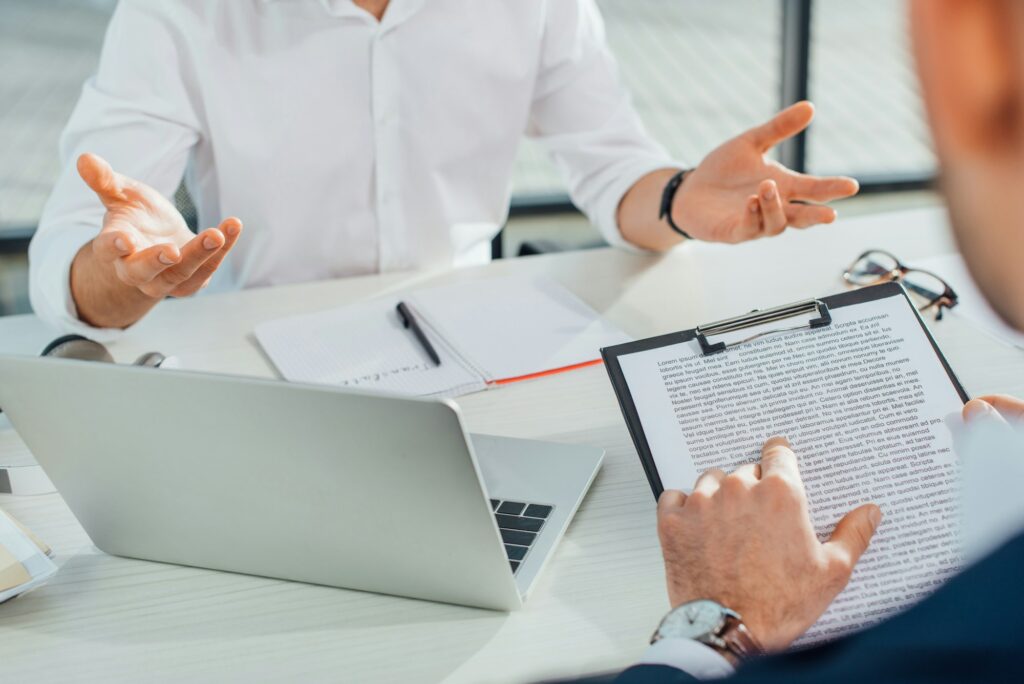 cropped view of translator working with businessman and documents in office